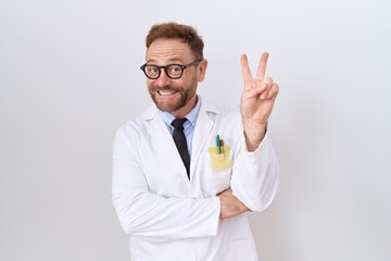 Middle age doctor man with beard wearing white coat smiling with happy face winking at the camera...
