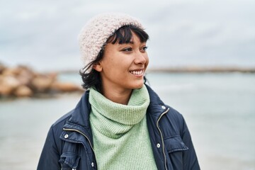 Young beautiful hispanic woman smiling confident standing at seaside