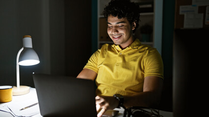 Young latin man business worker using laptop working at the office