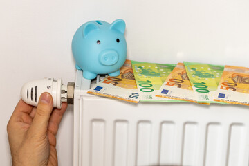 costs of heating apartments in winter in the European Union, energy and economic concept, hand unscrewing the radiator, piggy bank and euro money