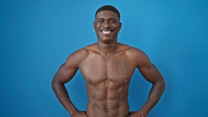 African american man smiling confident standing shirtless over isolated blue background