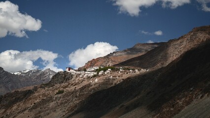 Scenic view of a mountain side, featuring several houses on the peaks