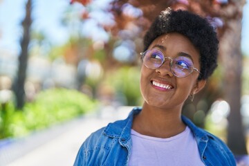 African american woman smiling confident looking to the side at park