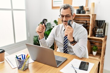 Middle age grey-haired man business worker press hands at office