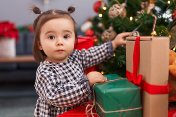 Fototapeta na wymiar Adorable chinese toddler decorating christmas tree at home