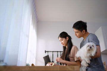 Couple prepare food at kitchen.