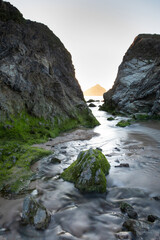 A small stream flowing into the sea at Holywell bay, Cornwall.
