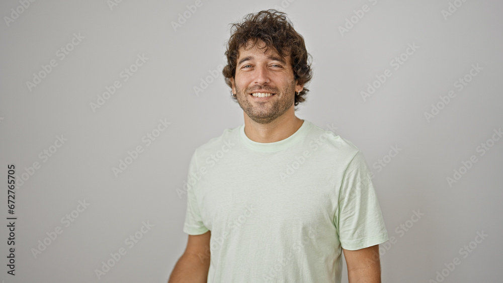 Sticker Young hispanic man smiling confident standing over isolated white background