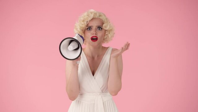 A woman is holding a megaphone, but she can't speak, her voice is gone. A woman in the image of spreads her hands, shrugs her shoulders on a pink background.