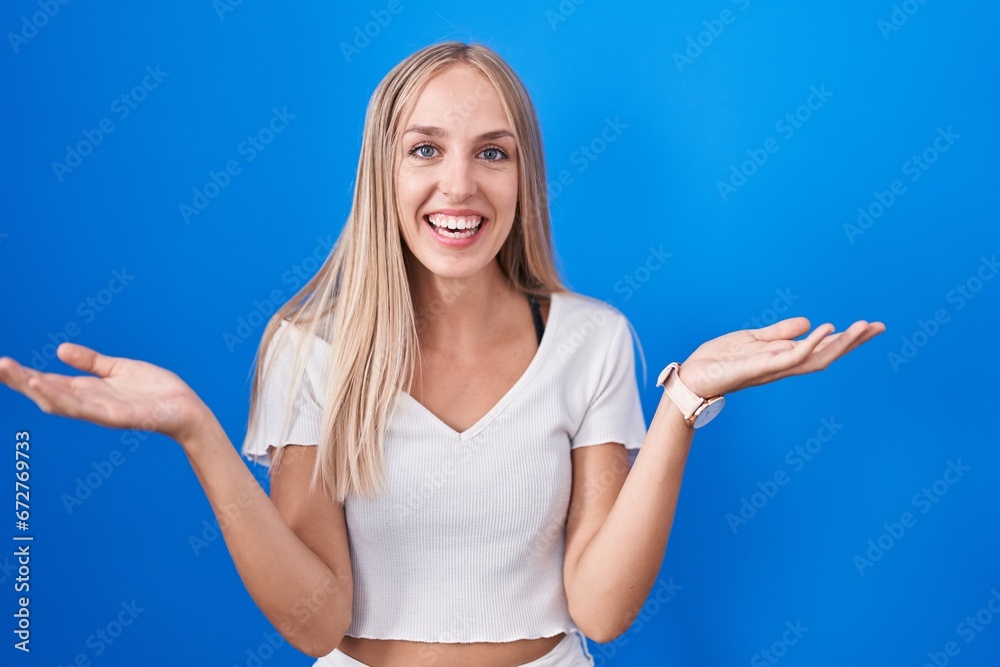 Sticker Young caucasian woman standing over blue background smiling cheerful with open arms as friendly welcome, positive and confident greetings