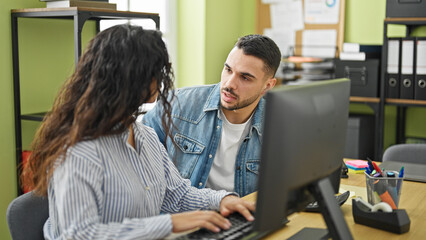 Man and woman business workers using computer working at the office