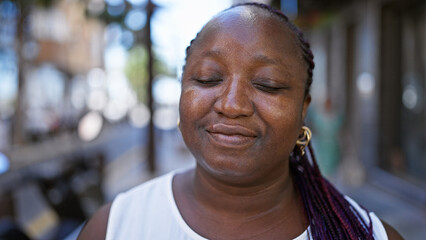 Fototapeta premium African american woman breathing with closed eyes at street
