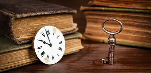 Old clock face, key and books, escape room game, time banner background