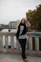 Blond wonderful woman with black dress in autum dance in the wind