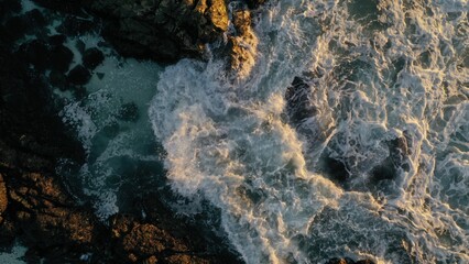 Waves spilling over rocks, photo taken in Cape Town, South Africa.