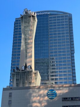 LOS ANGELES, CA, SEP 24, 2023: top of AT&T building, with distinctive microwave antennae, in Downtown. Gas Company Tower in background with Deloitte logo