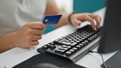 Grey-haired man business worker shopping with computer and credit card at the office