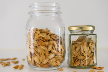 Two jars with pepitas on a kitchen table
