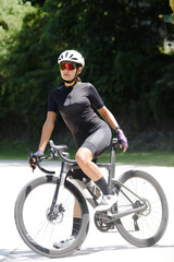 Concept woman riding bike.Cyclist Woman riding bike in helmets go in sport outdoor .Health care.