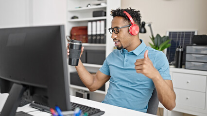 African american man business worker listening to music dancing at office