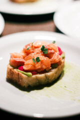 Salmon tartare on toast with green sauce, great for culinary arts and food blogs