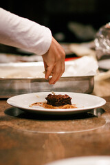Garnishing a brownie with almond slivers, perfect for image stock and recipe sites.
