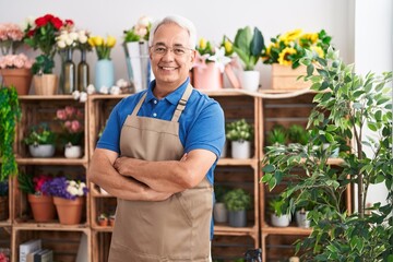 Middle age grey-haired man florist smiling confident standing with arms crossed gesture at florist