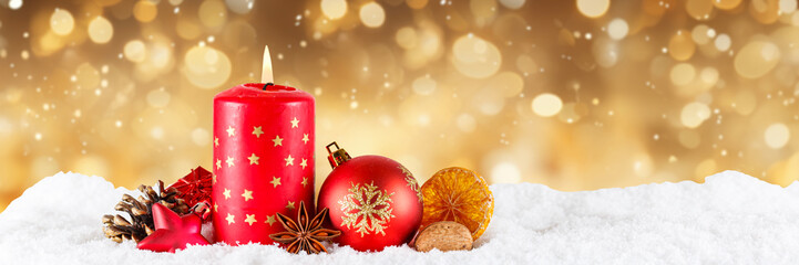 Christmas card advent time with burning candle decoration banner golden background with copyspace...
