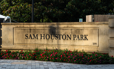 Sam Houston Park sign in Houston, Texas, in sunset
