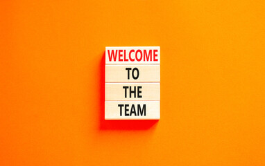 Welcome to the team symbol. Concept words Welcome to the team on beautiful wooden block. Beautiful orange table orange background. Business, motivational and welcome to the team concept.