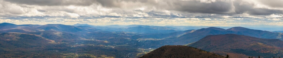 Panorama view of mountain ranges and clouds from top of Mount Equinox facing different directions on a beautiful autumn day
