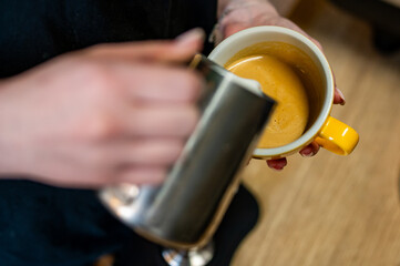 Fototapeta na wymiar Barista hand making cappuccino Coffee with espresso and milk in cafe