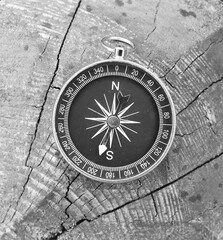 black and white photo of round compass