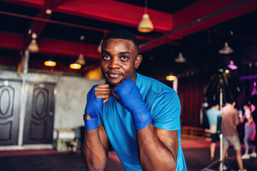 Obraz premium Boxer training in Boxing Club. Boxing fighters training at gym. Strong muscular Man practicing box in gym..
