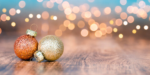 Christmas Baubles on wooden table and defocused lights in the background. Copy Space