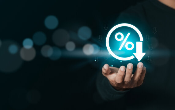 Businessman holding percent symbol and arrows down for cost reduction and quality control, cost optimization for products or services to improve customer satisfaction.