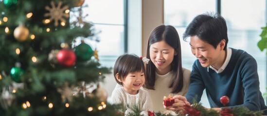 Asian Family celebrating christmas new year and. Home holiday and Christmas tree