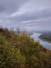 A river with trees and a body of water in the background