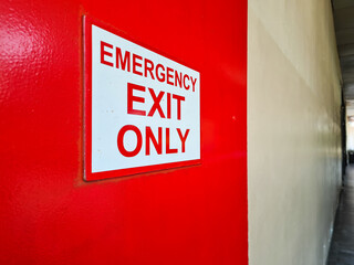 emergency exit signs on red doors in office buildings and malls.