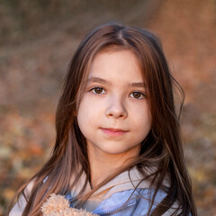 Fototapeta premium Portrait of a beautiful girl looking at the camera