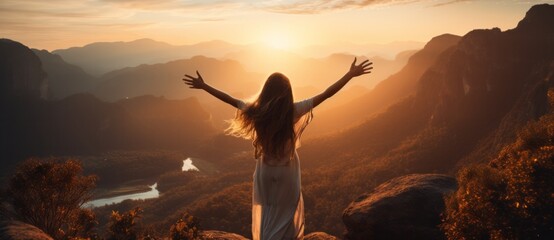 Fototapeta premium The Serene Embrace of Nature: A Woman Finding Solace in a Vast Field. A woman standing in a field with her arms outstretched as the sun goes down.