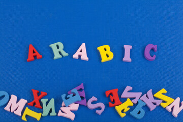 ARABIC word on blue background composed from colorful abc alphabet block wooden letters, copy space for ad text. Learning english concept.