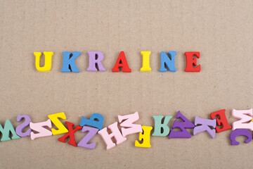 UKRAINIAN word on paper background composed from colorful abc alphabet block wooden letters, copy space for ad text. Learning english concept.