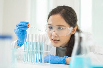 Medical development research laboratory, chemist or science woman scientist student in glass, glove looking pipette for test analysis liquid samples in clinic lab. Microbiology, analysing for medicine