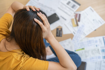 Financial owe asian woman, female sitting expression stressed by calculate expense from invoice or...