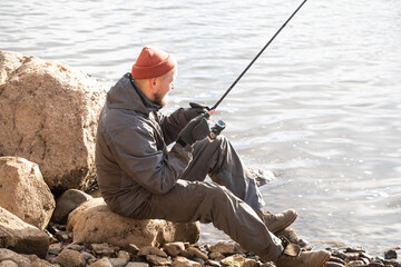 fisherman fishing on the river bank