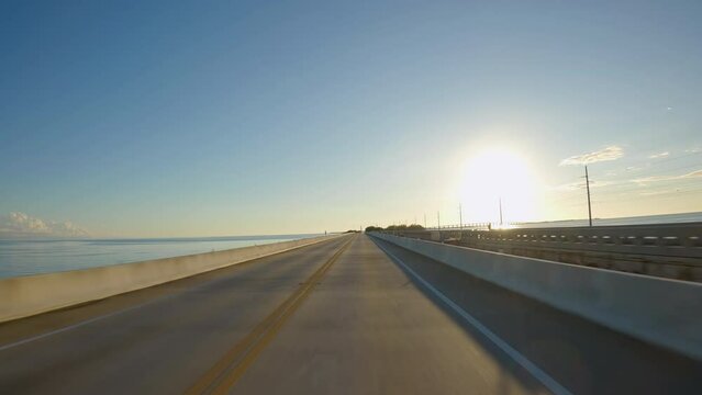 POV Driving a car towards sunset on Overseas Highway Bridge, Florida Keys