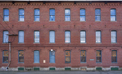facade view of old factory building with red brick wall