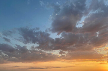 Atmosphere sunset horizon landscape. Colorful blue and gold sky with dark cloud
