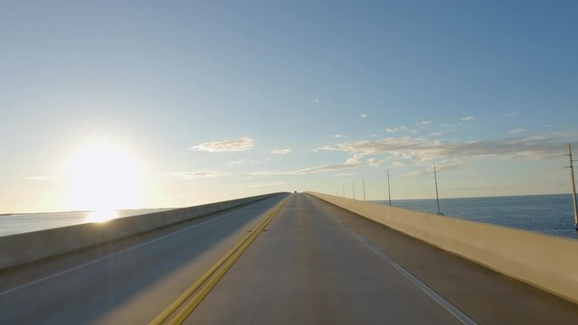 POV Driving a car up on Overseas Highway Bridge Florida Keys towards sunset